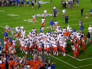 Post-game Gator team cheer along with the band and the fans